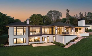  A modern home glowing at sunset on Lake Minnetonka, featuring Marvin Modern Multi-Slide door, Marvin Modern Casement windows, and Marvin Modern Direct Glaze windows. 