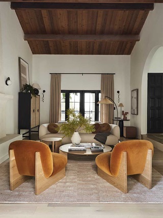 A modern living room in the Bobby Berk Firm’s office, featuring Marvin Ultimate Inswing French doors and modern furnishings.