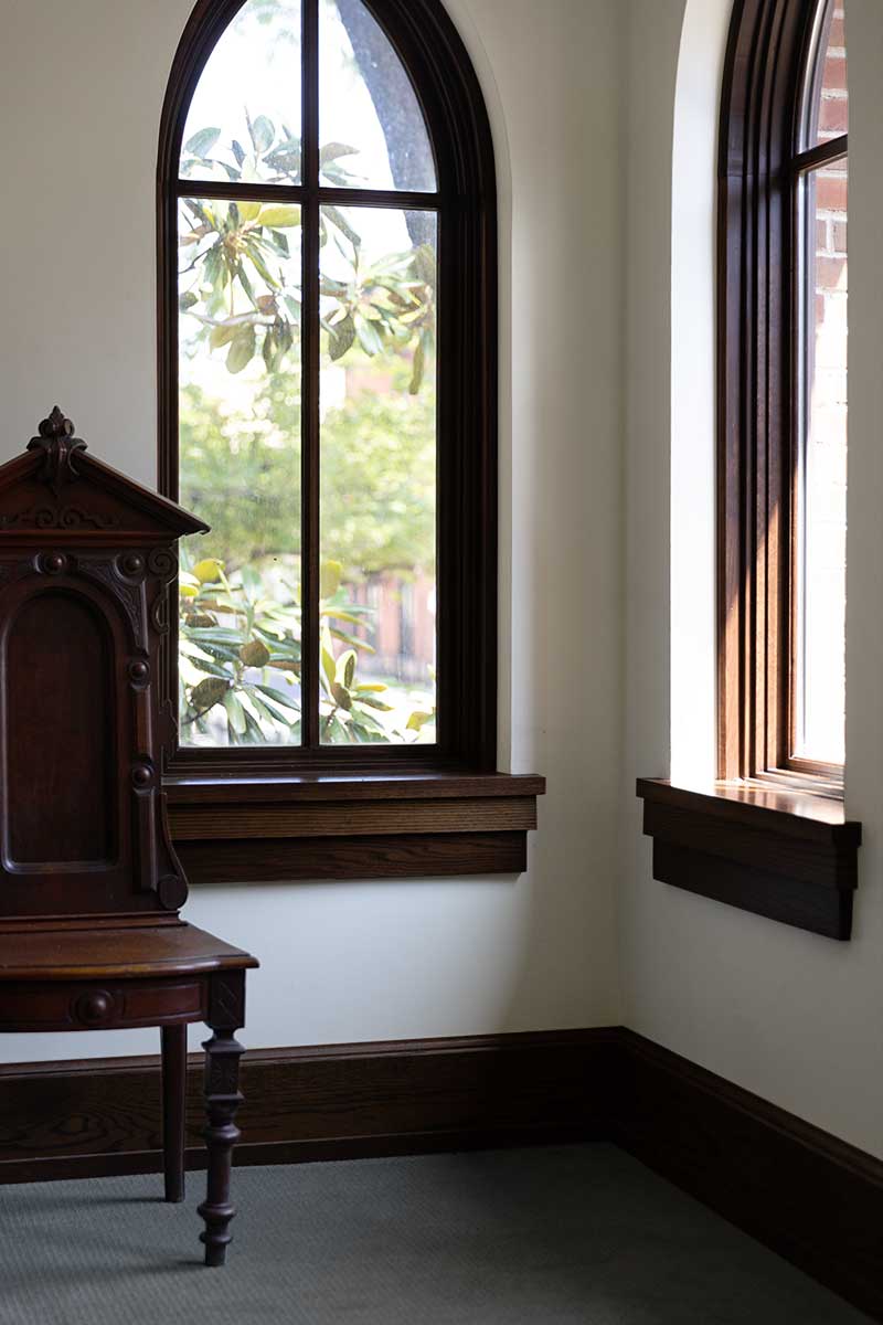 The corner of a room with arched windows inside Christ Episcopal Church in Reading, PA.