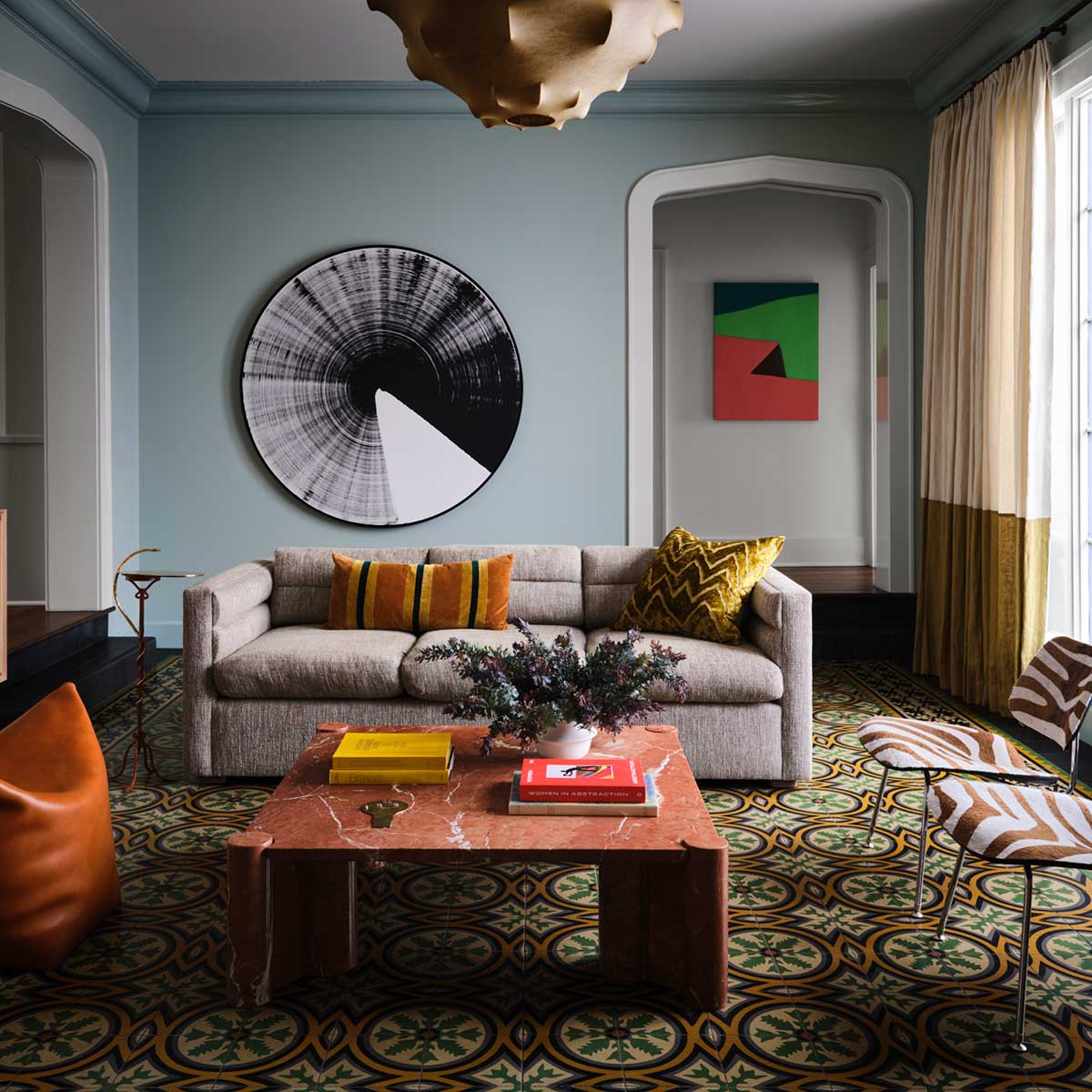 A living room with colorful art and decor, photographed by Douglas Friedman.