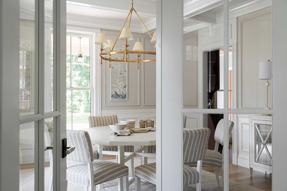 Looking into a dining area with Marvin windows in the historic Hadley House through TruStile doors.