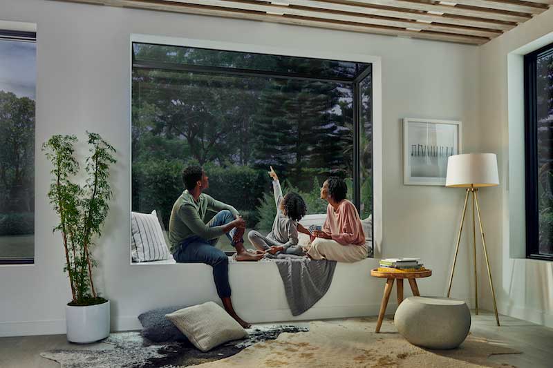 A family sitting inside their Marvin Skycove at night looking at the stars.