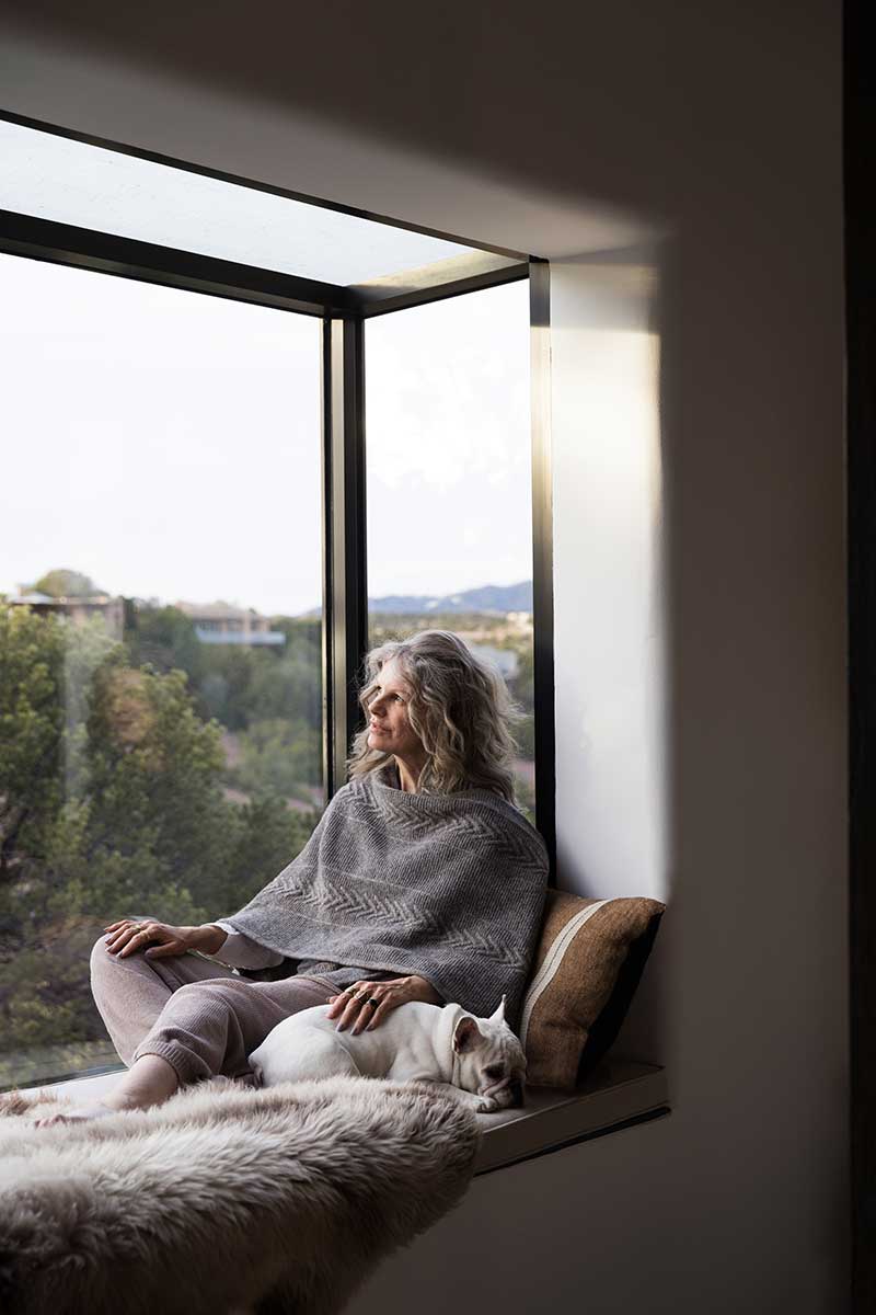 Woman sitting inside Marvin Skycove window box