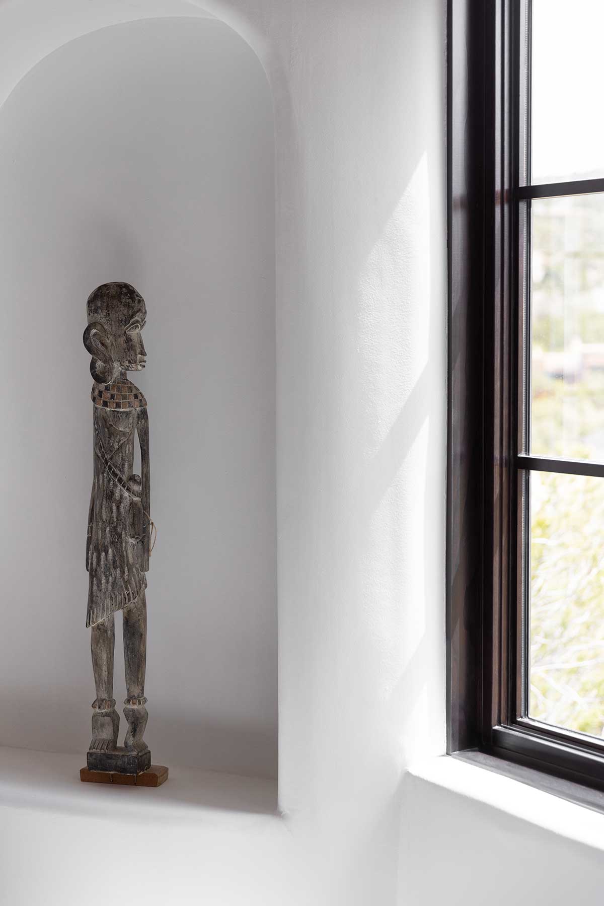 A statute in a room facing a Marvin Ultimate Casement Picture window.