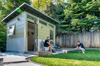 A green Studio Shed Accessory Dwelling Unit (ADU) featuring Marvin Essential windows.