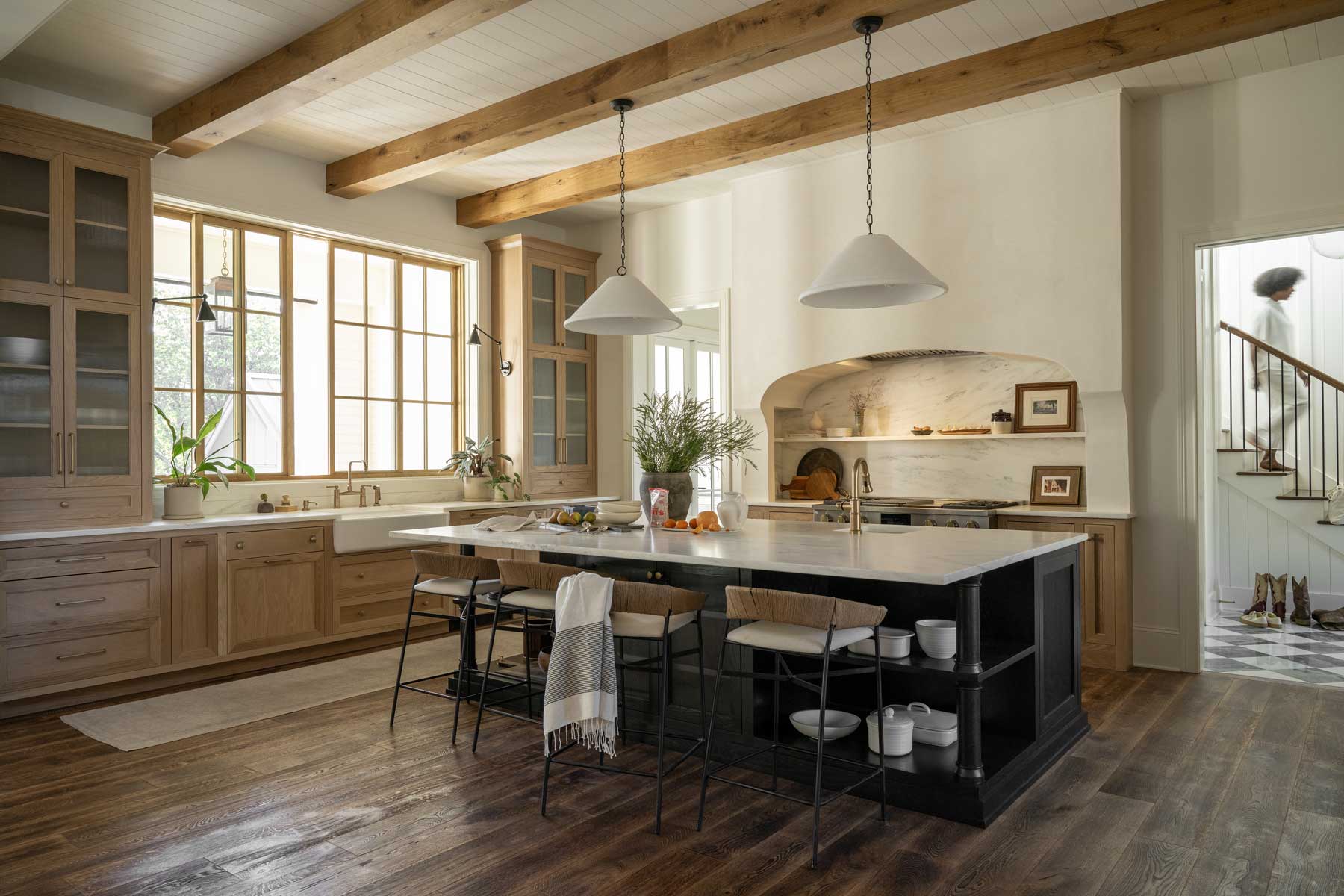 The large, open kitchen of the Southern Living Idea House 2023 in Leiper's Fork, TN, featuring a Marvin Glide window out onto the back porch.