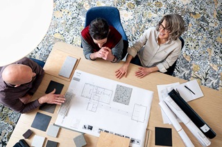 Group of people around a table discussing Marvin windows and doors