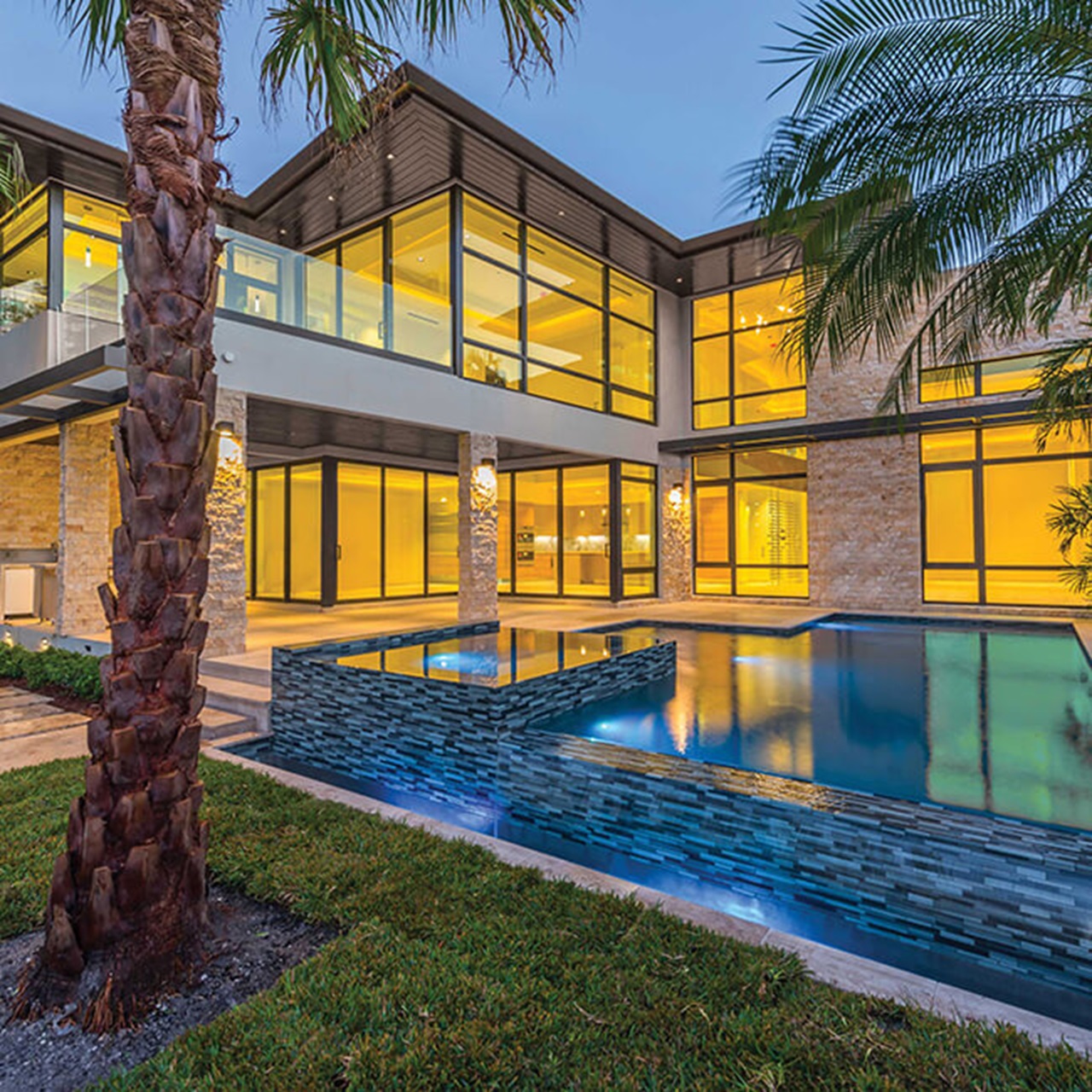 Exterior of home with Marvin Signature Coastline Awning Direct Glaze Narrow Frame Casement Windows and Multi-Slide Door