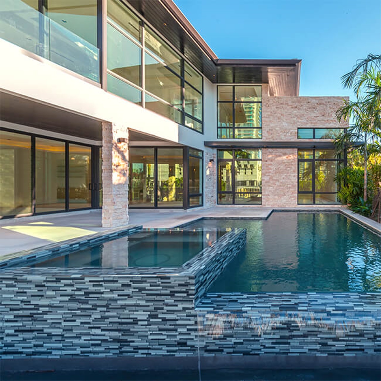 Exterior of home with Marvin Signature Coastline Picture Narrow Frame Awning and Casement Windows and Multi-Slide Door