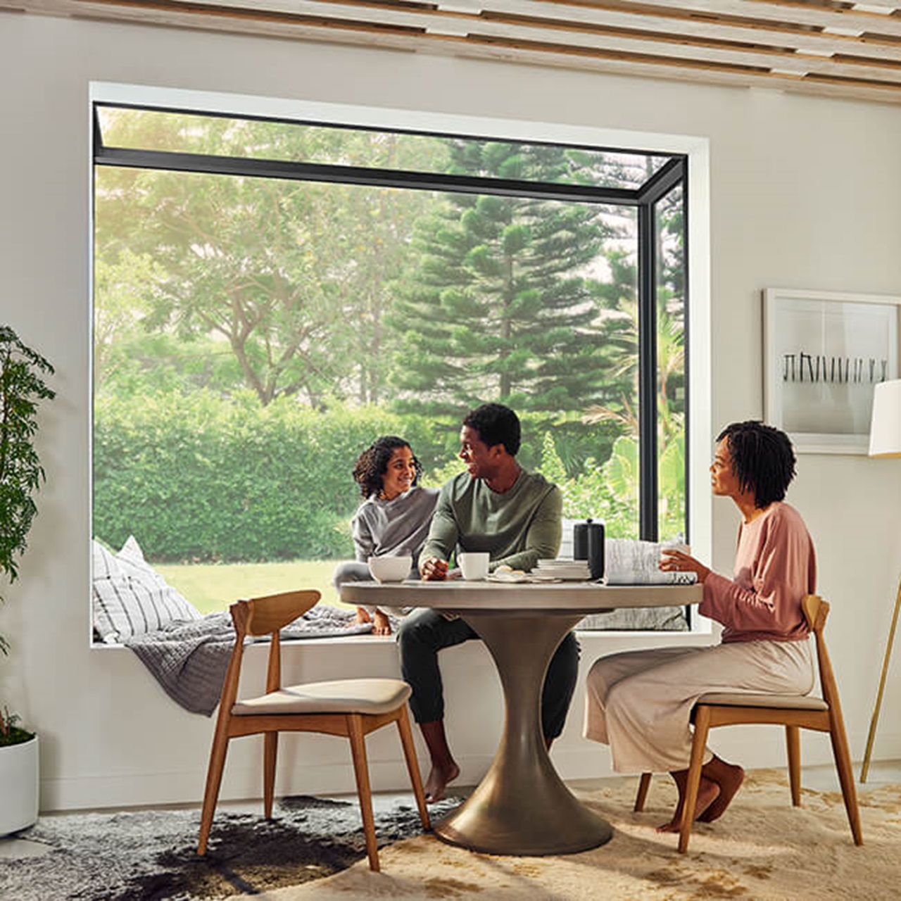 Interior of home with family sitting at kitchen table with Marvin Skycove window box in the background