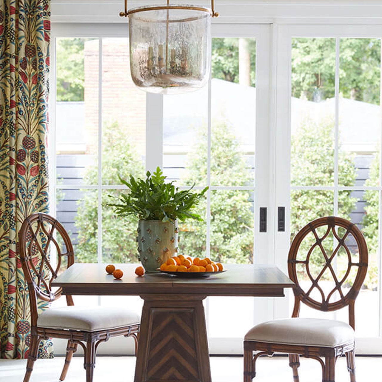 Table And Two Chairs In Front Of A Signature Ultimate Multi-Slide Door