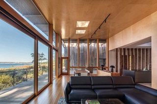 A living room with Marvin Signature Ultimate Direct Glaze Rectangle window and a multi slide door